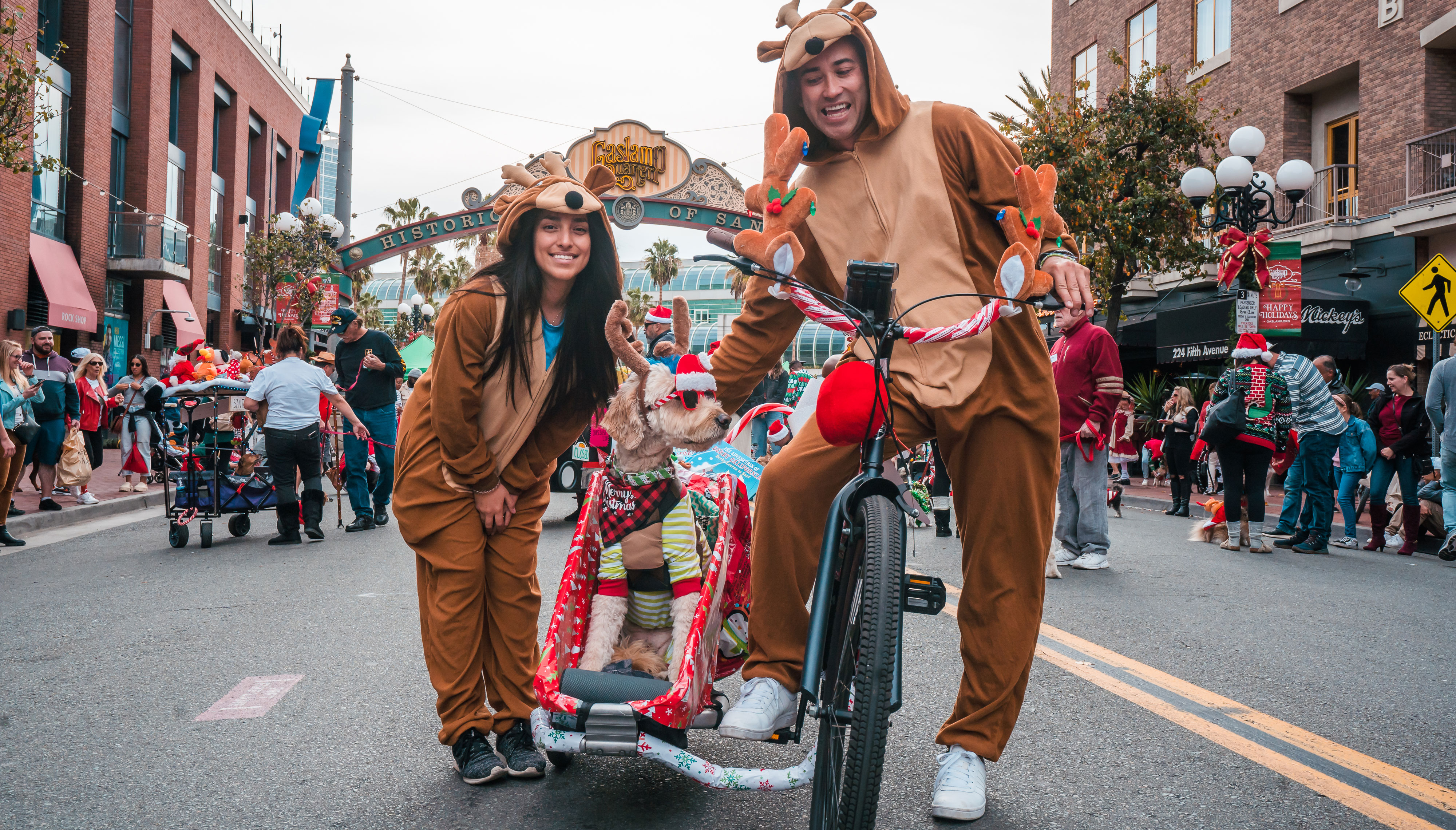 man and woman dressed in Christmas costumes with do